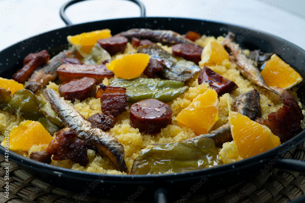 Bread crumbs with chorizo, green pepper, orange, bacon and fried anchovies. Traditional Spanish tapa. Bread crumbs with chorizo, green pepper, orange, bacon and fried anchovies. Traditional Spanish tapa.