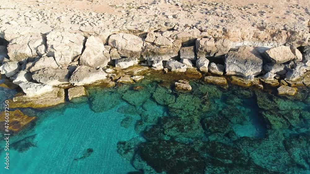 Aerial landscape at the edge of the earth, Turquoise calm sea waves beat against a rocky cliff, Ocean breeze, purity and untouched nature, Geological wonder, Cyprus Aerial landscape at the edge of the earth, Turquoise calm sea waves beat against a rocky cliff, Ocean breeze, purity and untouched nature, Geological wonder, Cyprus
