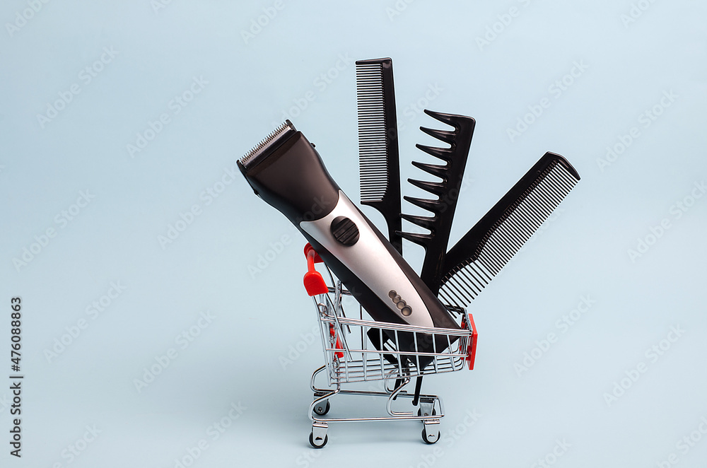 Hairdressing tools in a mini supermarket trolley. Clipper, scissors, combs. Shop idea for hairdressers. Hairdressing salon and haircut training.Online learning.Black Friday discounts Hairdressing tools in a mini supermarket trolley. Clipper, scissors, combs. Shop idea for hairdressers. Hairdressing salon and haircut training.Online learning.Black Friday discounts