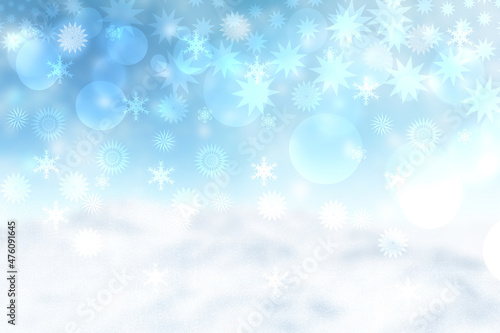 Abstract blurred festive winter christmas background with shiny blue and yellow white bokeh lighted snow landscape with stars and blue sky.