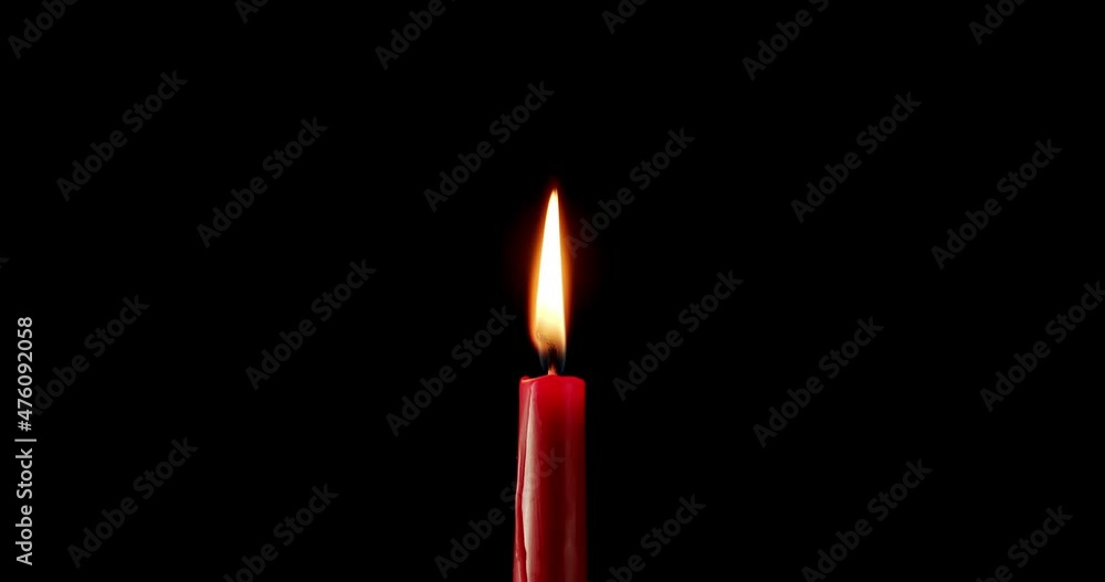 Candle on a black background. The flame of the candle slowly flickers. One candle slowly flickers. Ideal for background or over-layer with blending mode add, screen, lighten. Candle on a black background. The flame of the candle slowly flickers. One candle slowly flickers. Ideal for background or over-layer with blending mode add, screen, lighten.