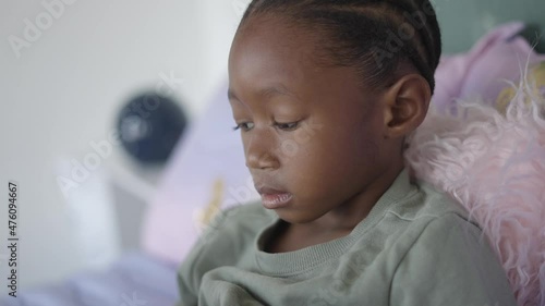 Black Girl with Cornrows Reading a Book