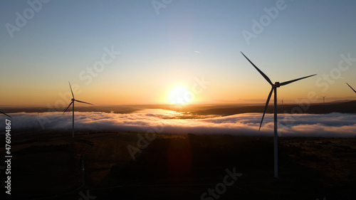 Wind power plant at sunrise. Aerial photography