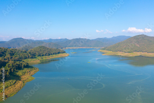 Aerial top view of a dam with forest trees, lake, river, mountain hills in travel and environment concept. Nature landscape background in Thailand.