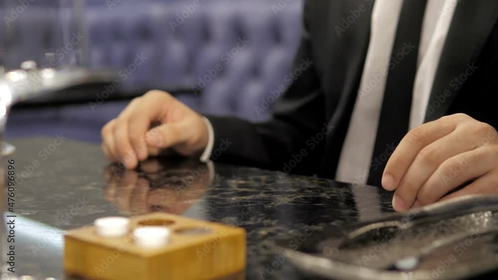 A waiter serving food to people in a restaurant. Close-up of a waiter putting plates of food on the table in a cafe. The chef's hands serve the octopus dish to the client. A client in a jacket and tie A waiter serving food to people in a restaurant. Close-up of a waiter putting plates of food on the table in a cafe. The chef's hands serve the octopus dish to the client. A client in a jacket and tie