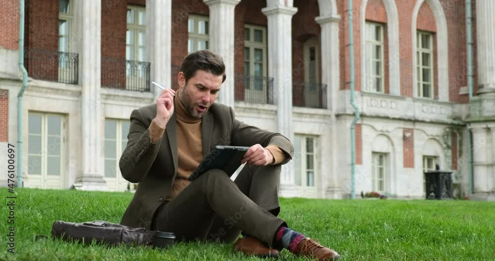 Student doing homework in the park. college student reads a tablet in the campus park. businessman in suit in brown shoes and stylish socks drinks coffee near a tree. man has lunch time Student doing homework in the park. college student reads a tablet in the campus park. businessman in suit in brown shoes and stylish socks drinks coffee near a tree. man has lunch time