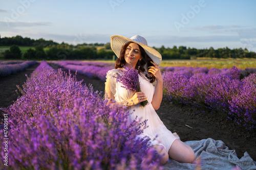 Girl in a lavender field in a white dress and hat