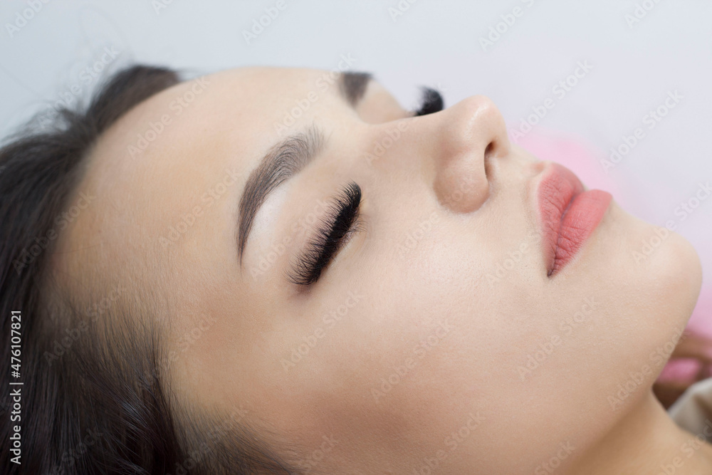 Eyelash extensions. Close-up of the eyes with thick black eyelashes. Macro. Expressive look Eyelash extensions. Close-up of the eyes with thick black eyelashes. Macro. Expressive look
