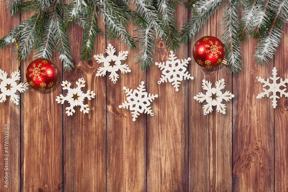 Fir branch with Christmas decoration on a painted wooden background. Fir branch with Christmas decoration on a painted wooden background.