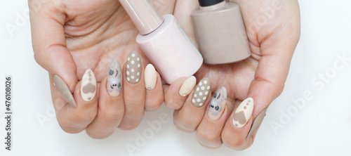 Manicure. Nails are brown, beige with a pattern. Shellac, gel polish