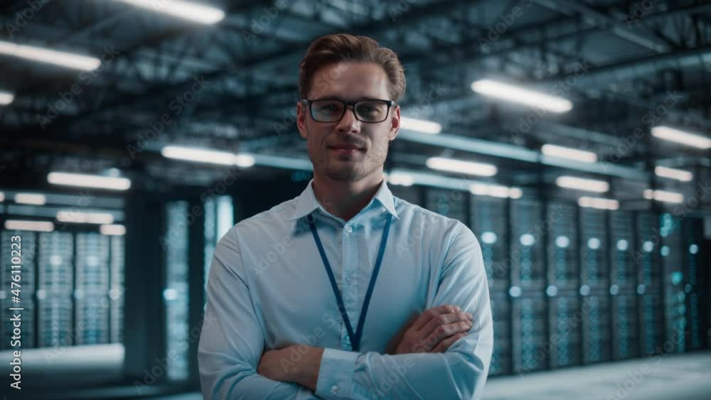 Big Data Center Portrait of Smiling Chief Technology Officer Wearing Glasses Walks into Focus, Looks at Camera. Cloud Service Warehouse with System Administrator. SAAS, Cloud Computing, Cyber Security Big Data Center Portrait of Smiling Chief Technology Officer Wearing Glasses Walks into Focus, Looks at Camera. Cloud Service Warehouse with System Administrator. SAAS, Cloud Computing, Cyber Security