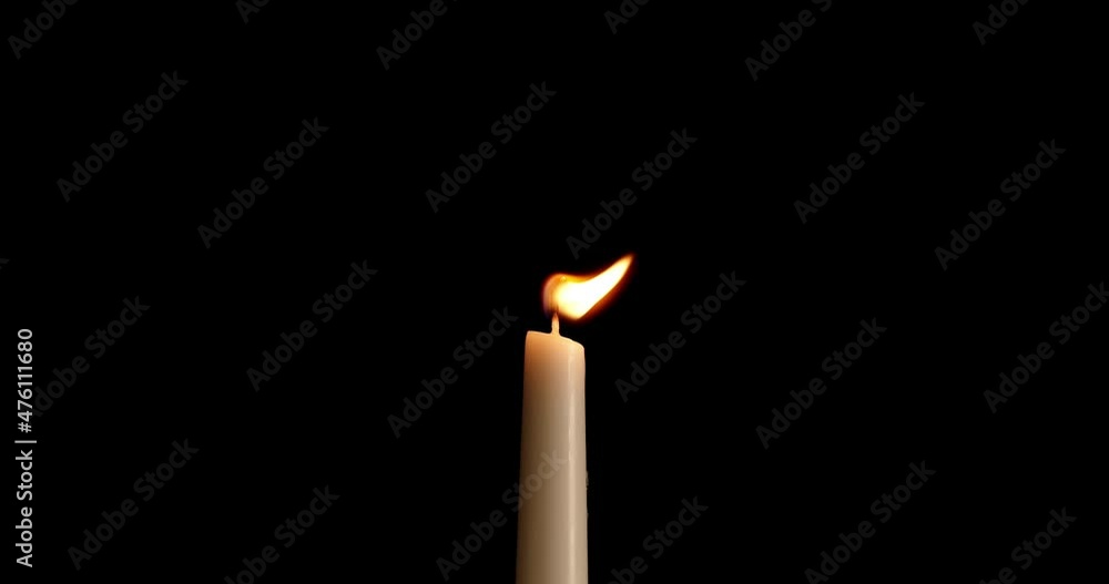 Candle on a black background. The flame of the candle slowly flickers. One candle slowly flickers. Ideal for background or over-layer with blending mode add, screen, lighten. Candle on a black background. The flame of the candle slowly flickers. One candle slowly flickers. Ideal for background or over-layer with blending mode add, screen, lighten.