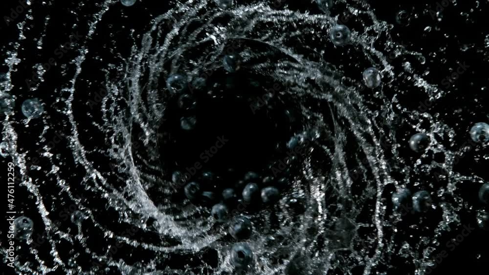 Super slow motion of rotating blueberries with splashing water, top view. Filmed on high speed cinema camera, 1000 fps. Ultimate motion shot. Super slow motion of rotating blueberries with splashing water, top view. Filmed on high speed cinema camera, 1000 fps. Ultimate motion shot.