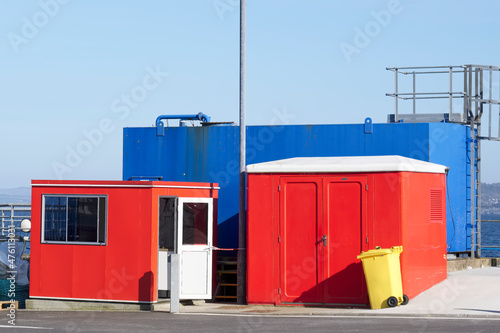 Red and blue storage containers at ferry port in Oban Scotland