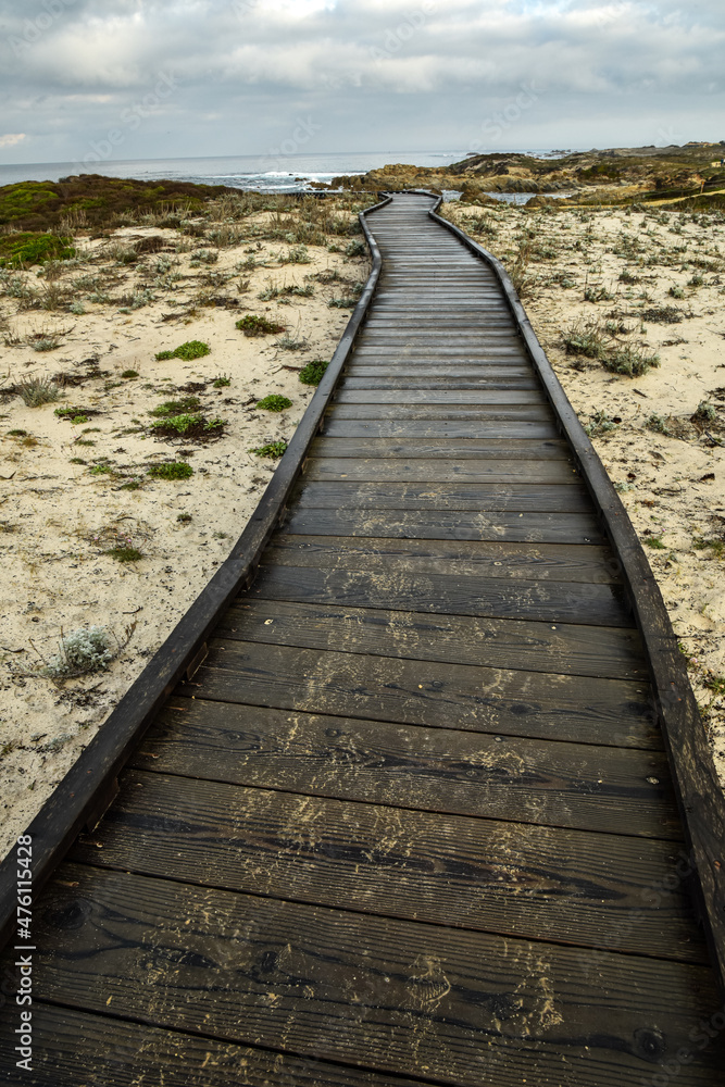 wooden walkway path over sand dunes to coastal shoreline of Monterey Bay on Pacific coast of California wooden walkway path over sand dunes to coastal shoreline of Monterey Bay on Pacific coast of California
