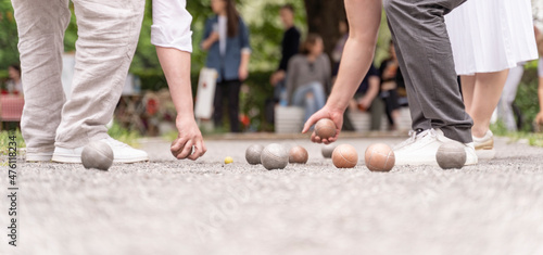 Bocce players collect boules after petanque outdoor game in city park