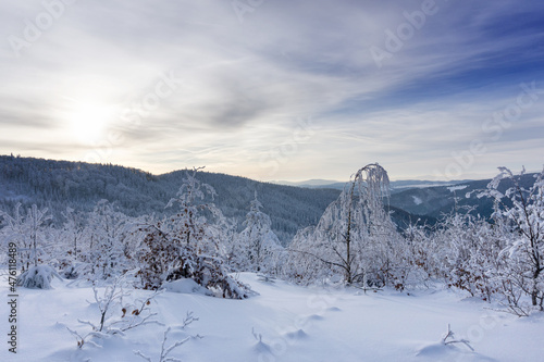 Winter mountain landscape, trees covered with hoarfrost and snow mountains and dramatic clouds in the sky. Kremnica Mountains, Slovakia. © msnobody