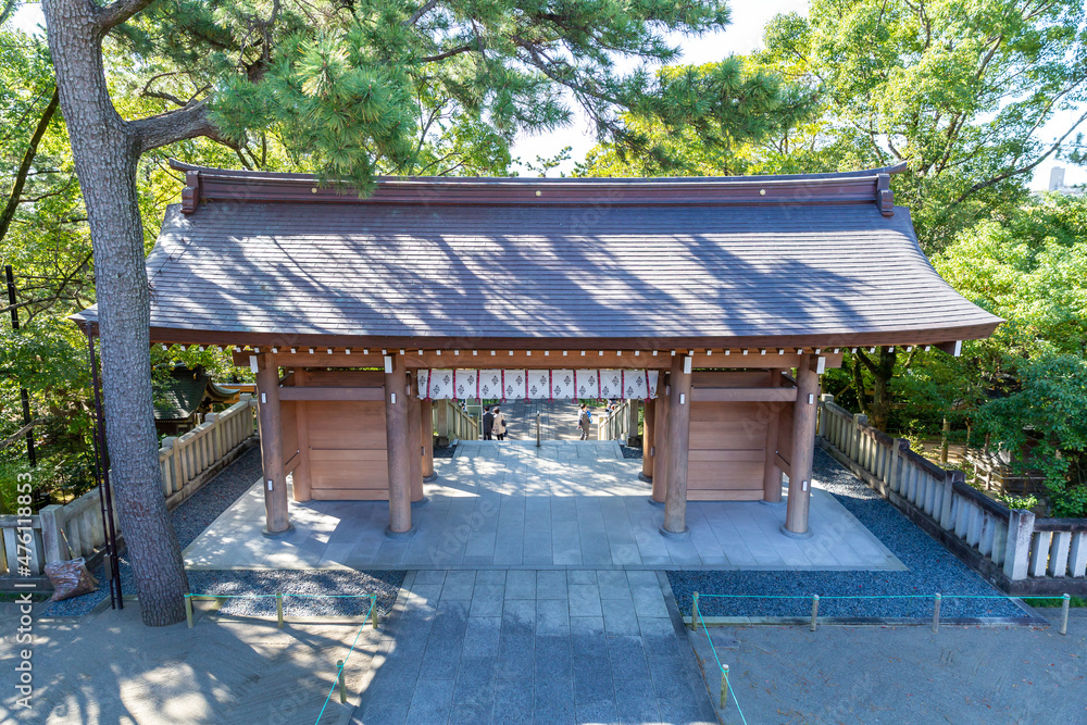 a gate of inage sengen shinto shrine surrounded by pine trees in autumn