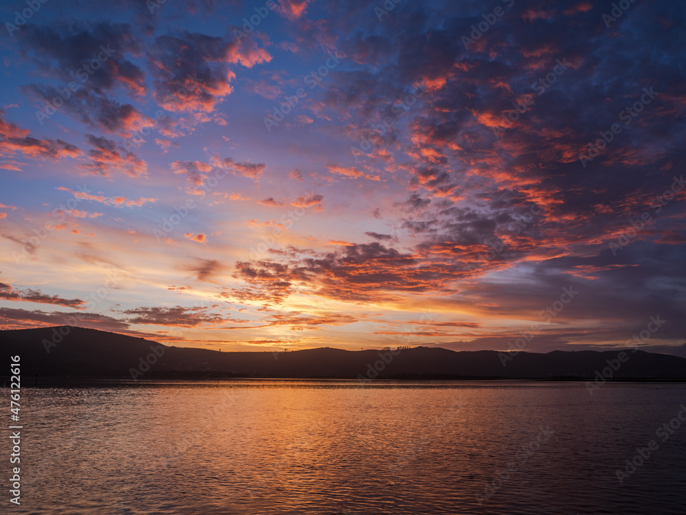 Colorful sunset with dramatic sky clouds over Knysna lagoon