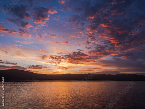 Colorful sunset with dramatic sky clouds over Knysna lagoon
