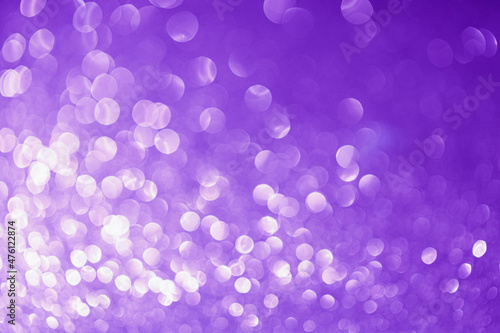 Festive abstract blurred glitter background purple color. Bokeh effect. Holiday decoration concept.