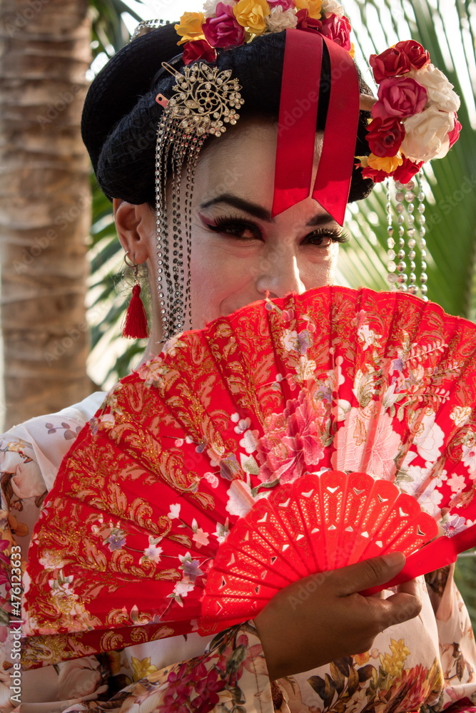 Portrait of latin woman wearing geisha costume with fan Portrait of latin woman wearing geisha costume with fan