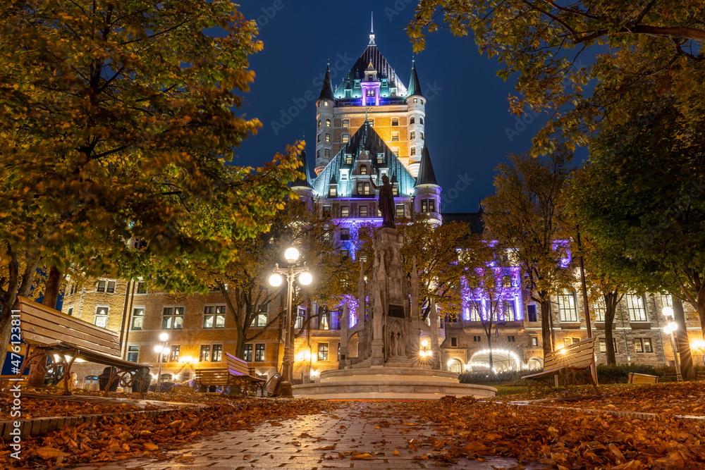 Night view of the Quebec City Old Town in autumn. Place d'Armes, landscaped plaza with a fountain.