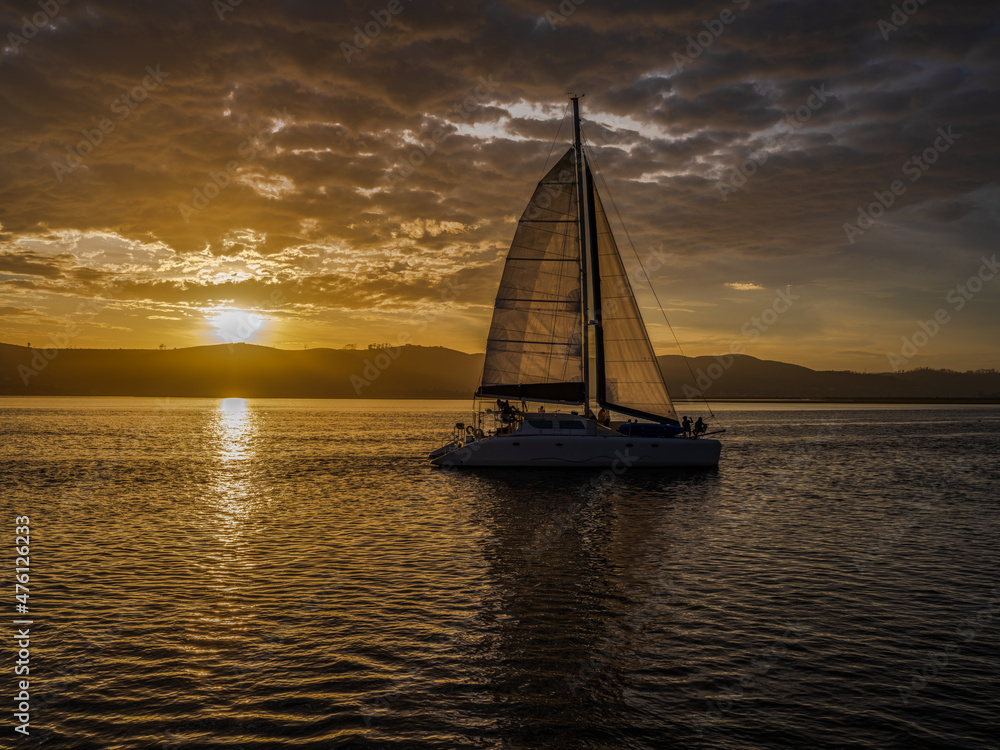 sailboat during a golden sunset in Knysna lagoon garden route