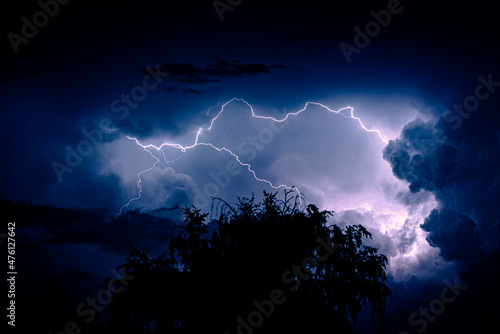 Night sky with lightning in a thunderstorm. Dramatic weather.