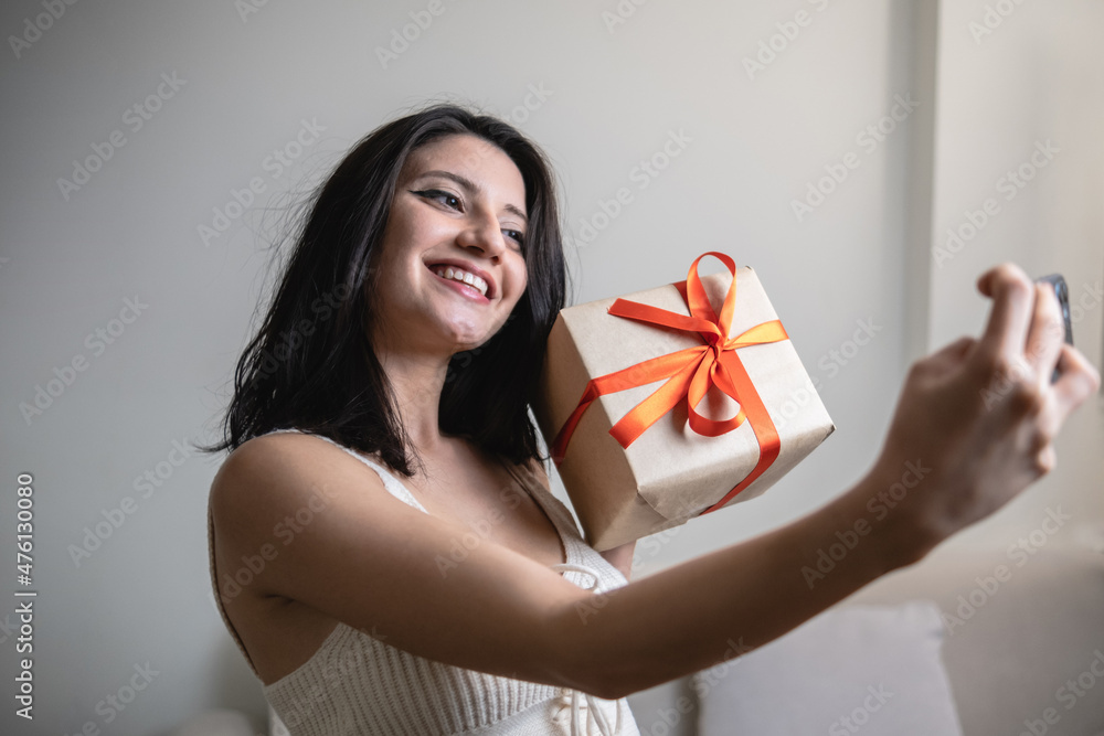 excited beautiful woman taking selfie with gift excited beautiful woman taking selfie with gift