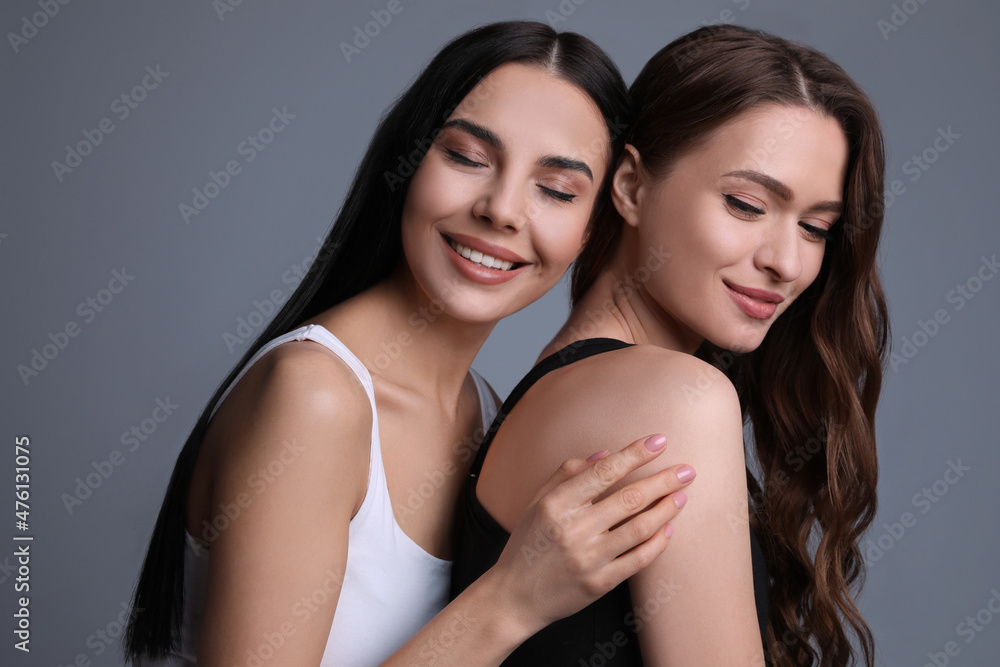 Portrait of beautiful women on grey background Portrait of beautiful women on grey background