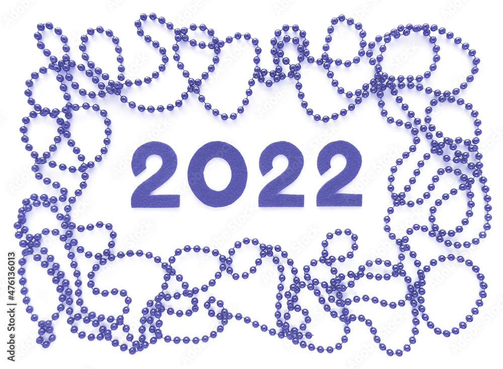 Violet felt numbers 2022 and beads around in trendy very peri Pantone color of the year 2022 on white background. Flat lay for Valentine's Day or New Year. Violet felt numbers 2022 and beads around in trendy very peri Pantone color of the year 2022 on white background. Flat lay for Valentine's Day or New Year.
