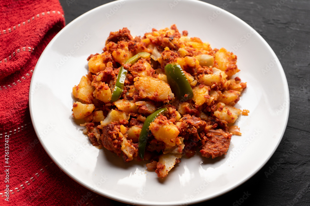 Potatoes with chorizo on a dark background.  Mexican food