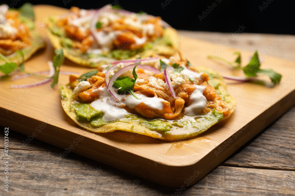 Chicken tinga tostadas with cheese and avocado. Mexican food