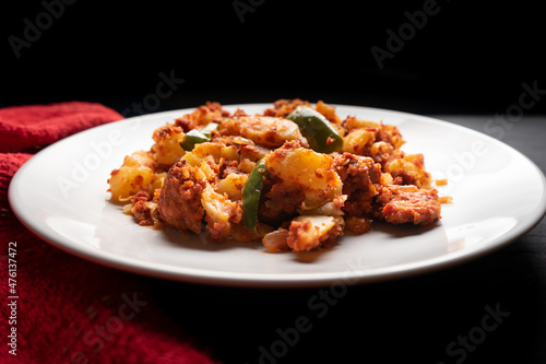 Potatoes with chorizo on a dark background. Mexican food