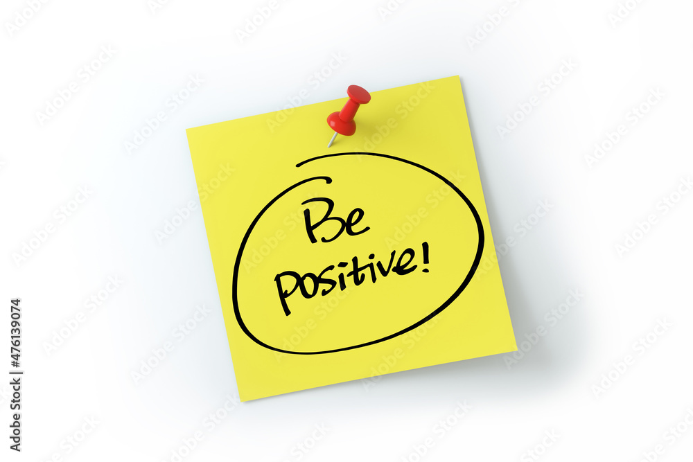 Be positive written on yellow sticker note over white background Be positive written on yellow sticker note over white background