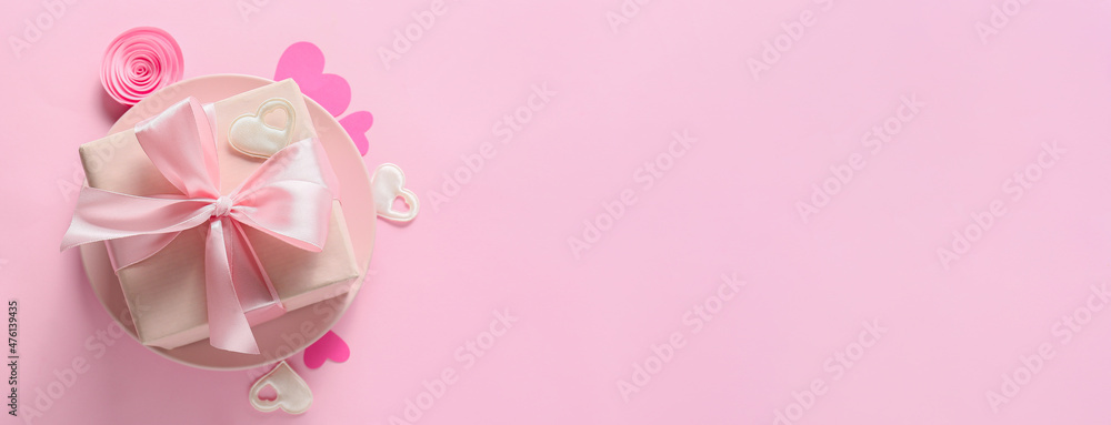 Present for Valentines Day on pink background with space for text
