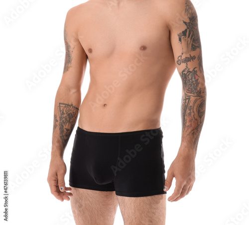 Handsome young man in underwear on white background