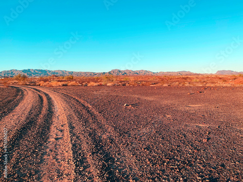 vintage photograph dry baron desert dirt road wilderness trail bright clear afternoon sky