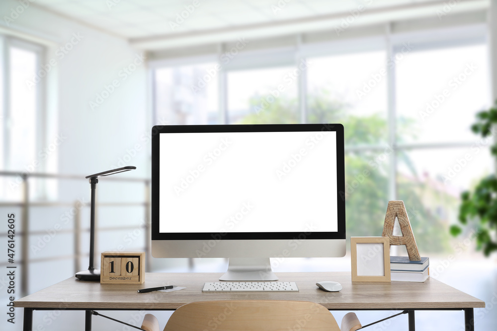 Fototapeta premium Workplace with modern computer on wooden table indoors. Mockup for design