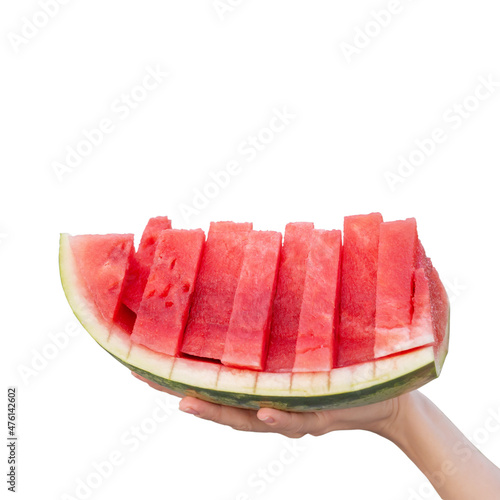 A female hand holds a piece of watermelon with ripe pulp cut into slices on an isolated background. Seedless red watermelon