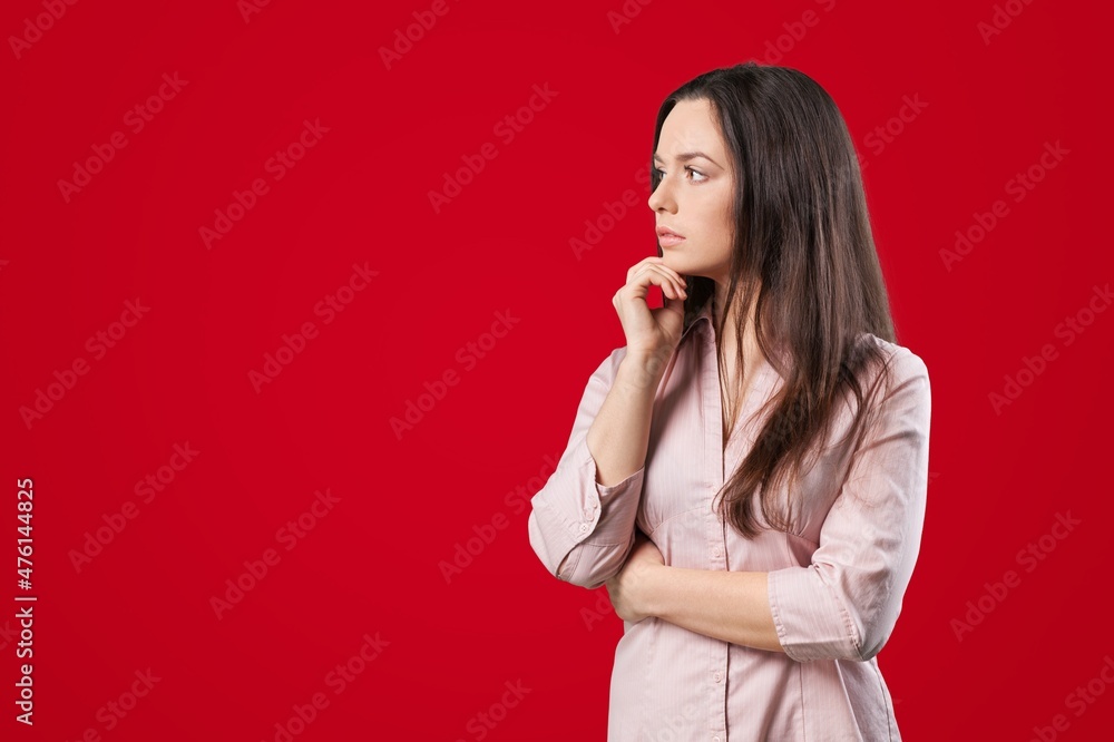 Photo of minded girl think thoughts look on bright red color background Photo of minded girl think thoughts look on bright red color background