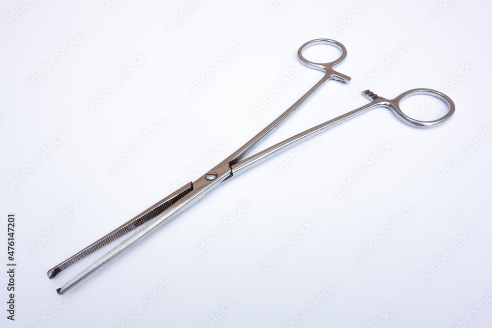 Medical clamp tweezers for operations on white isolate. Surgical instrument on a white background. Medical clamp tweezers for operations on white isolate. Surgical instrument on a white background.