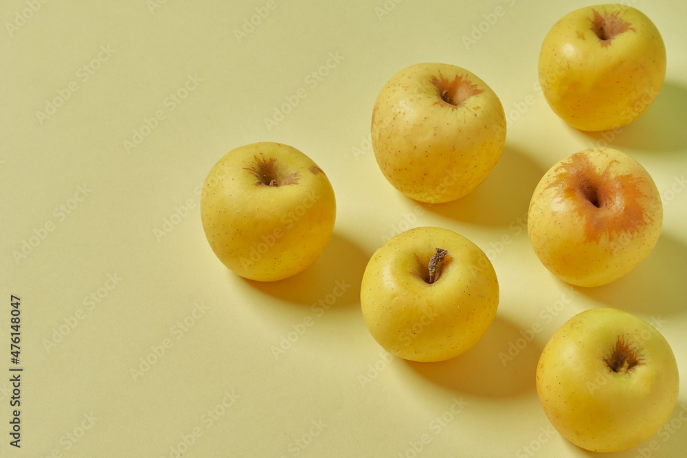 Yellow apple on pastel yellow background. Healthy apples. Yellow apple on pastel yellow background. Healthy apples.
