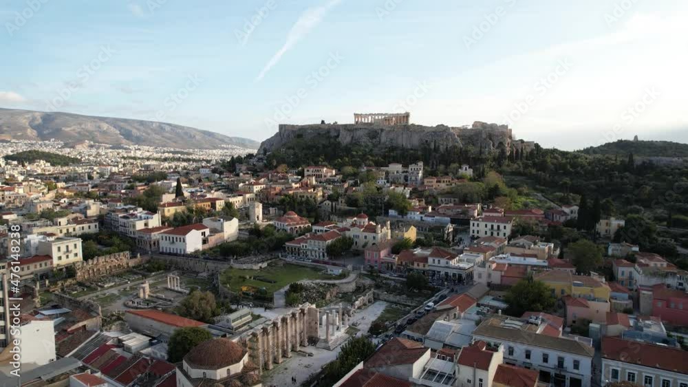 Aerial view away from the Acropolis rock and Monastiraki square in sunny Athens, Greece - pull back, drone shot