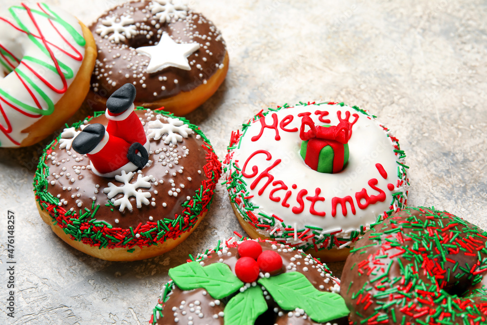 Tasty Christmas donuts on light background, closeup