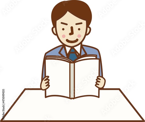 本を読むスーツを着た男性。