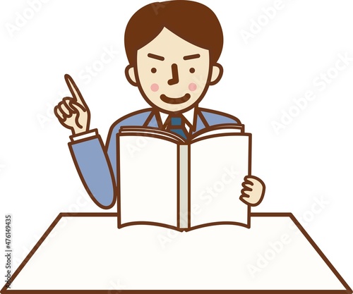 本を読みながら指を差すスーツ姿の男性。