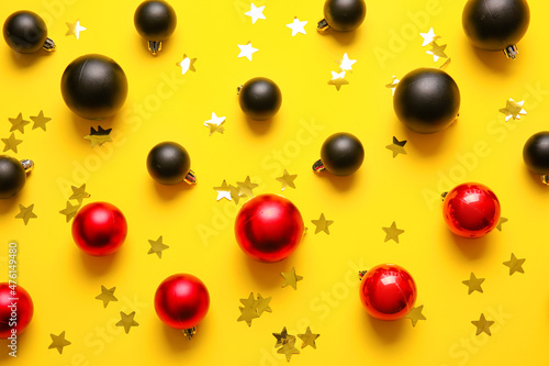 Stylish Christmas balls on yellow background