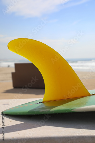 Photography Vertical shot of the detail of a surfing board at the beach